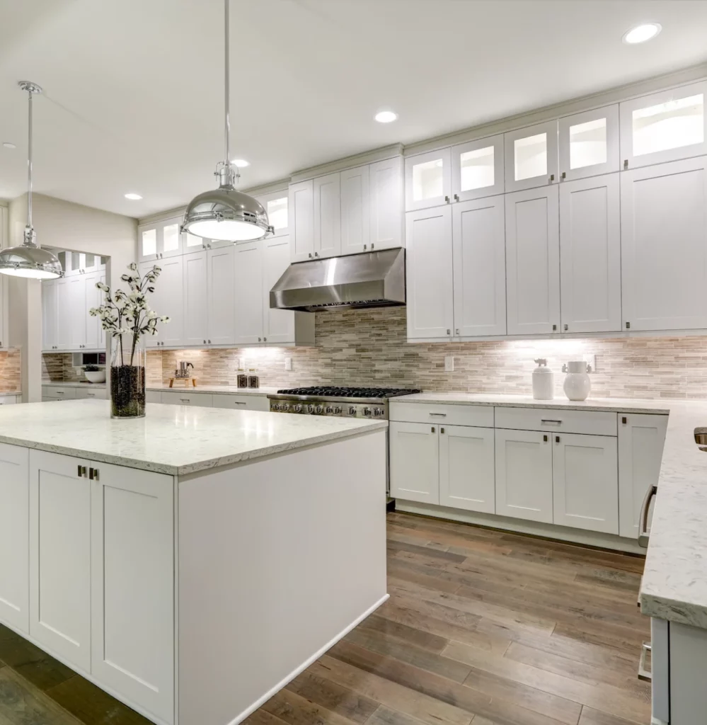 Kitchen remodeling with tile backsplash, granite counters and white cabinets and wood floors